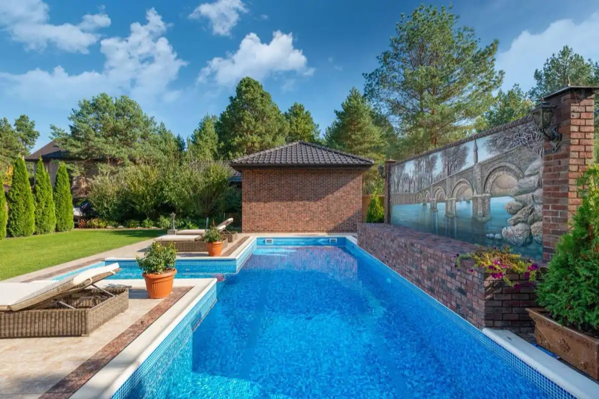 Backyard saltwater swimming pool in Brownsville, TX on a clear day